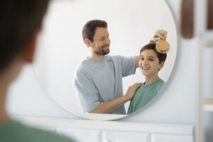 side-view-smiley-father-brushing-kid-s-hair